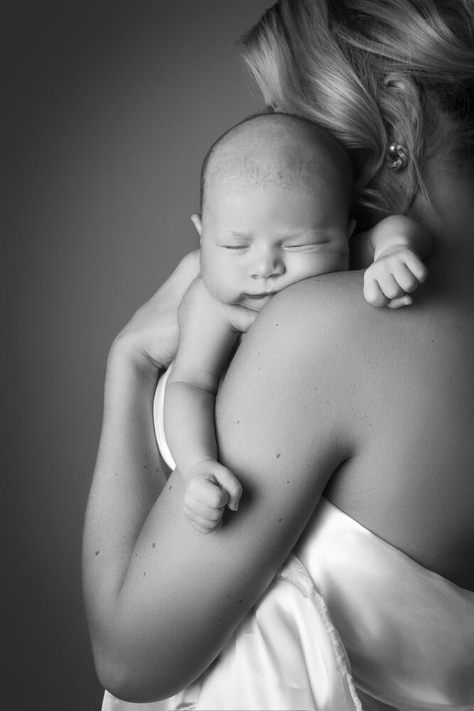 black and white image of a mother and newborn baby