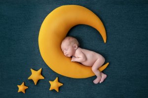 Baby asleep on a moon with stars