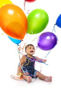 Toddler playing with balloons