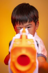 Child holding a nerf gun ready to shoot
