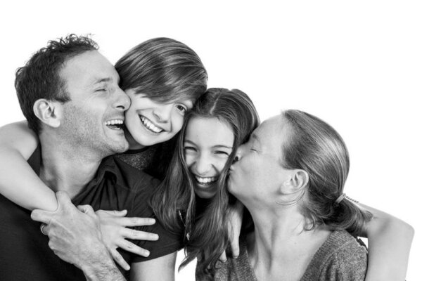 Black and white image of a family cuddling each other