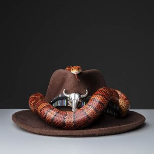 Snake wrapped round a cowboy hat