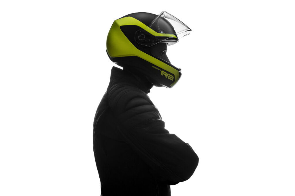 A silhouette image of a man wearing a motorcycle helmet
